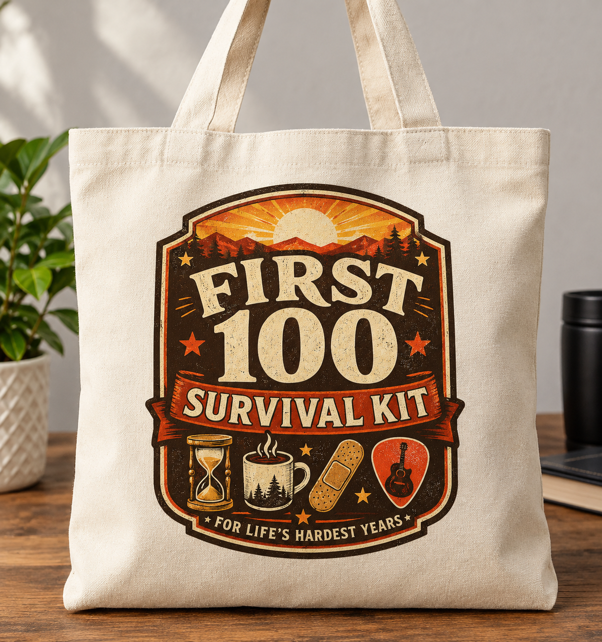 Cream canvas tote bag with vintage badge graphic reading First 100 Survival Kit